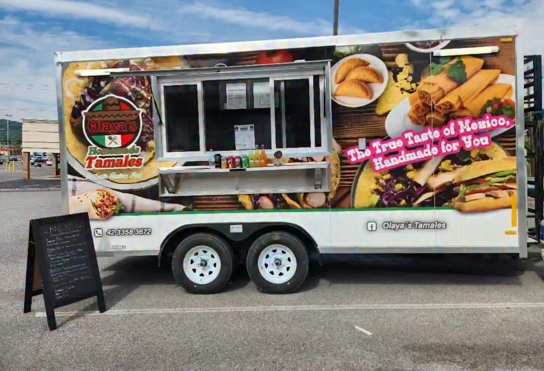 Side view of the wrapped Olaya's Tamales food truck.
